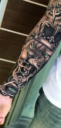 Enhance your phone's display with a stunning hyperrealistic live wallpaper featuring an intricate sleeve tattoo of a lion with a crown in amazing detail