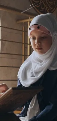 Introducing a stunning live wallpaper featuring a woman wearing a hijab, engrossed in reading a book