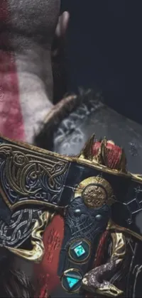 This live phone wallpaper is a striking close-up shot of a sword-wielding character wearing detailed viking rune armor and an ornate mask with accompanying fabrics
