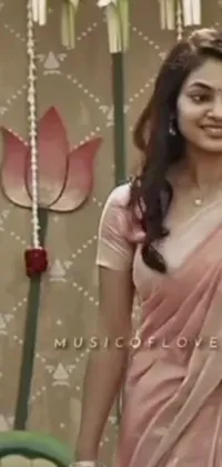 This phone live wallpaper showcases a beautiful woman in a pink sari poised for the camera