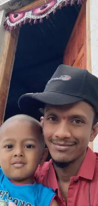 This live wallpaper showcases a happy man and child posing for a photo in a style inspired by hurufiyya art