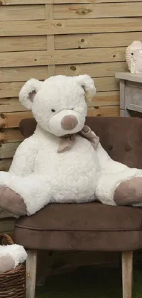 This charming live wallpaper for phones features a beautifully crafted white teddy bear sitting on a rustic chair against a backdrop of the serene garden of Avalon