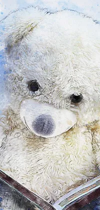 This phone live wallpaper features a white teddy bear deeply engrossed in reading a storybook