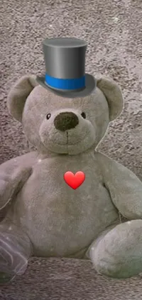 This live phone wallpaper features a charming teddy bear in a top hat and a light grey crown