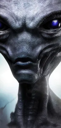 This phone live wallpaper features an alien with striking blue eyes in a frontal pose