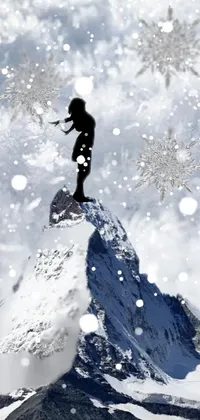This stunning phone live wallpaper features a person standing on top of a snow-covered mountain, wearing a unique outfit made of ice crystals