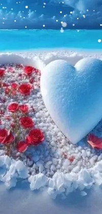 Looking for a stunning mobile wallpaper to beautify your phone screen? Check out this romantic and dreamy live wallpaper featuring an exquisite heart made from snow, set against a scenic beach backdrop