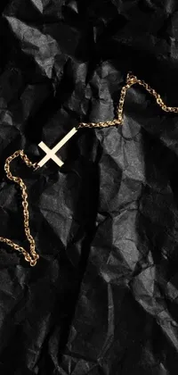 This dazzling live wallpaper showcases a close-up of a chain with a cross pendant on a black background with rich texture, creating a striking effect