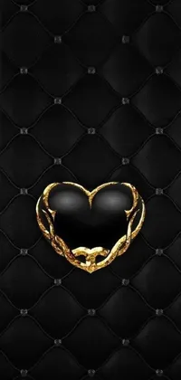 This phone live wallpaper showcases a black and gold heart on a black leather background