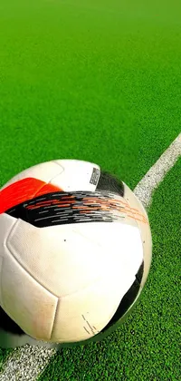 This dynamic live phone wallpaper features a soccer ball perched on a realistic, detailed soccer field