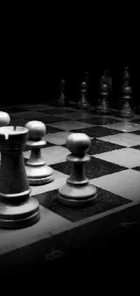 Enhance your phone with a sophisticated phone live wallpaper featuring a black and white photo of a chessboard