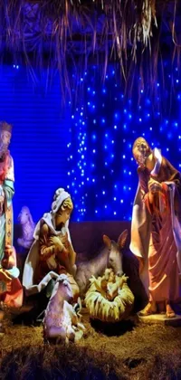 This live wallpaper depicts a beautiful nativity scene with glowing blue lights on a night skyline of Bangalore background, with soft snowfall and a brightly coloured star in the center
