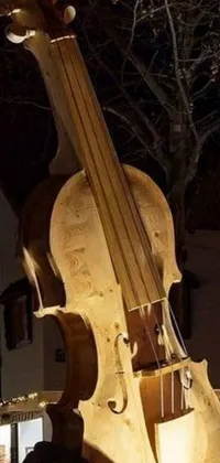 This stunning live wallpaper features a wooden statue of a violin in front of a musical building, complete with trumpets and sousaphones hanging on the walls