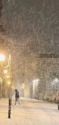 Enjoy a calming live phone wallpaper of a snowy street at night