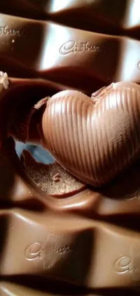 This live wallpaper showcases a luscious chocolate heart perched atop a stack of decadent chocolate bars
