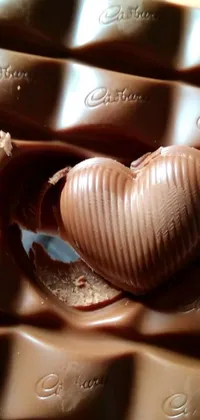 Indulge in the sweet delights of a chocolate heart and bars with this stunning live wallpaper for your phone