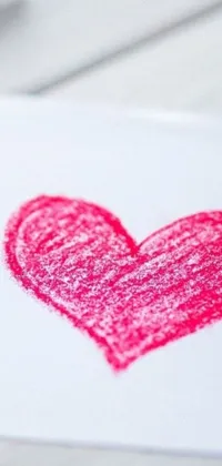 Get enchanted by this phone live wallpaper featuring a heart drawn with crayon on a paper background
