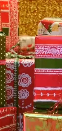 This lively <a href="/happy-wallpapers/christmas-wallpapers">Christmas phone live wallpaper</a> features a pile of presents decorated with colorful and patterned wrapping papers, ribbons, and bows, sitting in front of a blurred Christmas tree adorned with twinkling lights