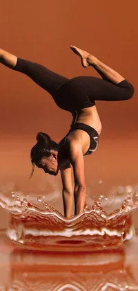 This live wallpaper for mobile phones features an intricate and stunning digital rendering of a woman performing a handstand in water