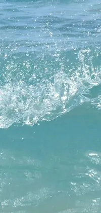 This live wallpaper features a dynamic scene of a surfer catching a wave in the ocean, with a swimmer seen in the background
