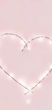 Illuminate your phone screen with this stunning heart-shaped live wallpaper designed with string lights on a pink background
