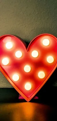 This live phone wallpaper features a heart-shaped light with a polka-dot pop-art design