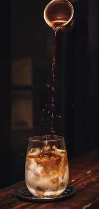 This live wallpaper features a refreshing scene of an iced coffee being poured into a glass, with perfect composition and lighting