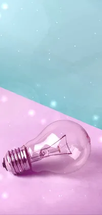 Transform your phone into a masterpiece with our stunning Light Bulb Phone Live Wallpaper! This wallpaper features a realistic 3D light bulb on top of a pink and blue surface, creating a modern and stylish desktop for your device