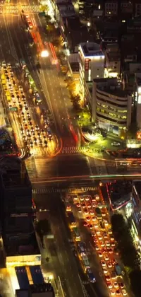 This live wallpaper showcases a bustling Japanese city street at night, captured from a high angle for maximum impact
