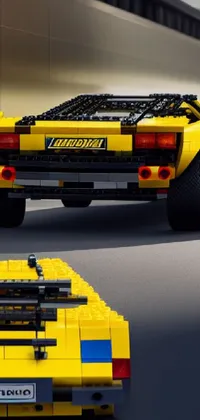 This live phone wallpaper showcases a stunning lego model of a yellow sports car inspired by the iconic Pantera (Countach) with a symmetrical design and incredible detail by a talented artist