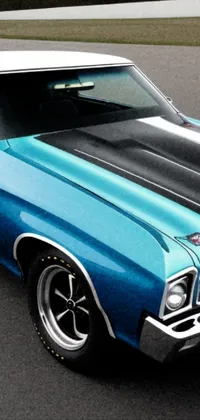 This amazing phone live wallpaper showcasing a blue muscle car parked in a deserted parking lot is perfect for car lovers