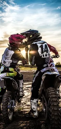 This live phone wallpaper depicts two individuals on dirt bikes