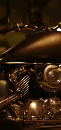 This live phone wallpaper features a finely crafted motorcycle parked on a dimly-lit street at night