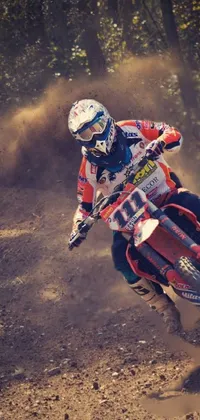 This live wallpaper features an invigorating image of a dirt bike rider speeding through a dirt track during the fall season