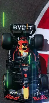 Enjoy the thrill of Formula One racing with this stunning live wallpaper featuring a Red Bull racing car driving on a race track