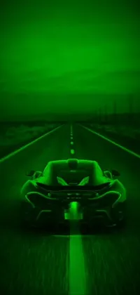 This live phone wallpaper features a green sports car speeding down a desert road at night, set against an AMOLED background for a futuristic look