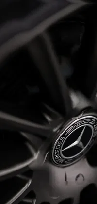 This live phone wallpaper showcases a top-tier Mercedes wheel in an up-close and detailed studio photograph