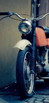 Get a stunning phone live wallpaper featuring a retro motorcycle parked on a Warsaw street