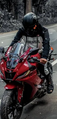 This phone live wallpaper will impress motorcycle fans with its lifelike depiction of a rider on a red motorbike