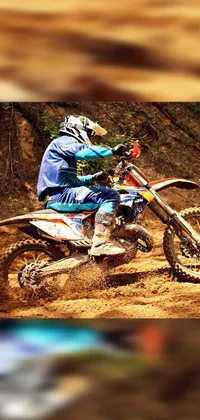 Looking for an electrifying live wallpaper that reflects your edgy personality? Look no further than this high-definition photo of a man mounted on a dirt bike! Against a background of bold orange and blue, this wallpaper captures the exhilaration and speed of off-road racing