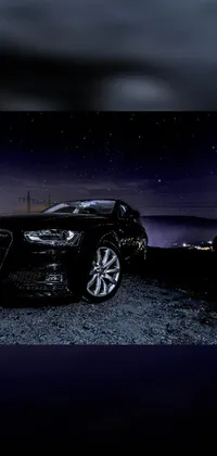 This live wallpaper for your phone displays a car parked on the side of a road at night