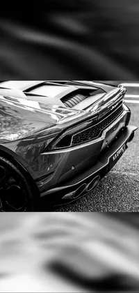 Looking for an edgy and cool live wallpaper for your phone? Look no further than this black and white sports car design