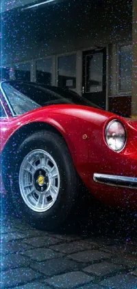 This dynamic phone live wallpaper features a vibrant red sports car parked in front of a building