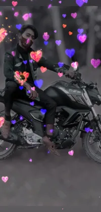 This stunning phone live wallpaper features a man on a motorcycle surrounded by pulsating hearts, with a striking picture bringing the scene to life