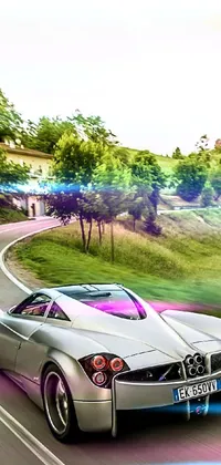 Elevate your phone's look with a stunning silver sports car driving down a curvy road live wallpaper