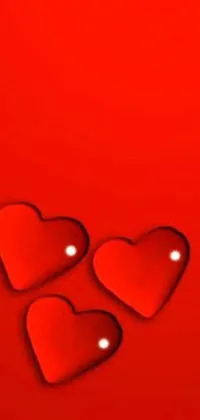 This lively phone live wallpaper features three hearts on a red background, each one sporting a unique shape and filled with vibrant shades of pink, orange, and yellow