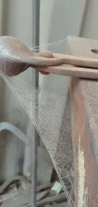 This live wallpaper features a wooden spoon and metal composition, complemented by dribbling paint, auto-destructive art, artificial spider webs, dust mist, levers, and a hinged jaw