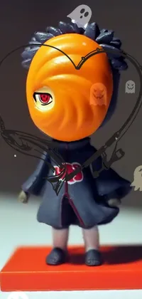 This phone live wallpaper is a stunningly unique design featuring a kawaii chibi style figurine with a black and orange coat in a shin hanga style