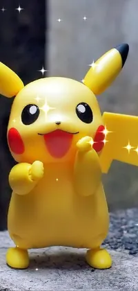 Looking for a high-quality phone live wallpaper? Look no further than this stunning Pikachu wallpaper! Featuring a close-up of a toy Pikachu standing proudly on a rock against a beautiful nature background, this wallpaper is incredibly detailed and vibrant
