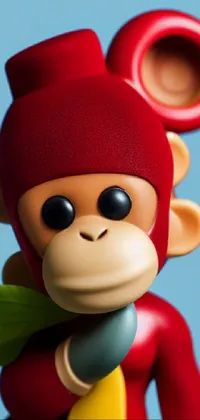 This live wallpaper features a close-up of a red-colored toy monkey holding a bright yellow banana